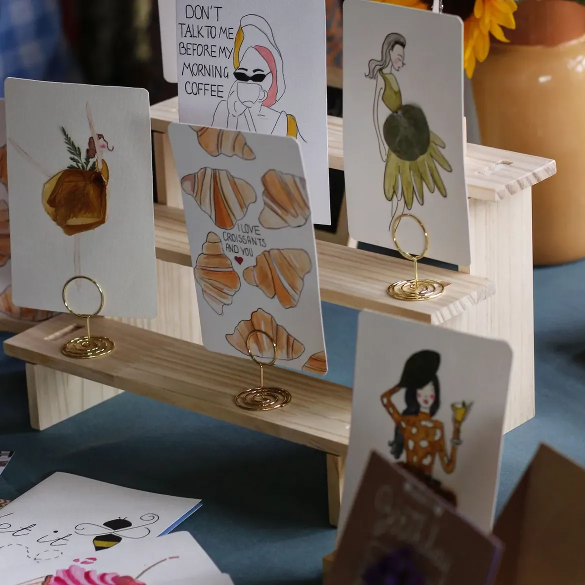 Visitors exploring handmade card designs